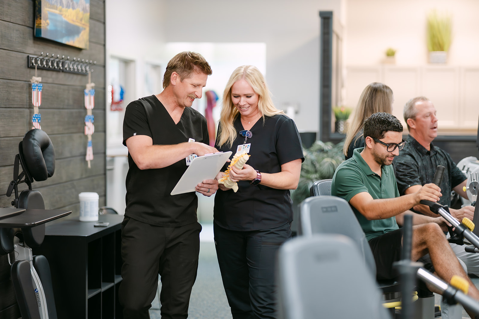 therapists discussing chart with happy patients