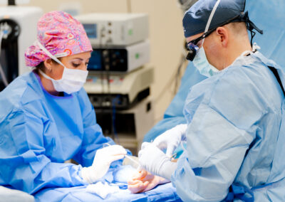 nurse and Dr Turner operating on thumb