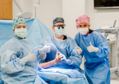 Dr. Turner and surgery nurses giving "thumbs up"